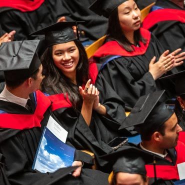 An overhead view of graduates sitting in their regalia during graduation