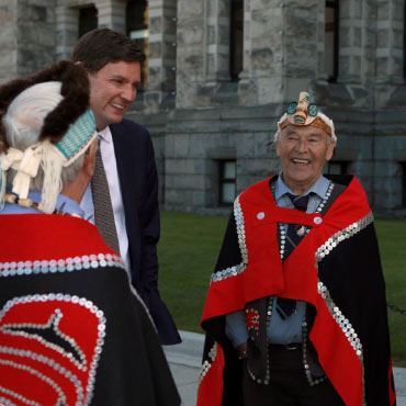 BC Premier David Eby gathers with Hereditary Chief Gitkun others after an event recognizing the Haida Nation's Aboriginal title throughout Haida Gwaii during a ceremony in the legislature in Victoria