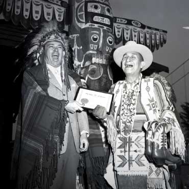 Two First Nations people proudly holding a certificate