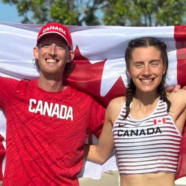 Evan Dunfee and Olivia Lundman holding Canadian flag together