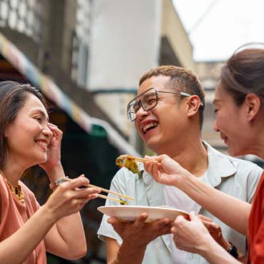 Three people enjoying food together