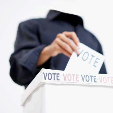 Headless figure places a ballot into box