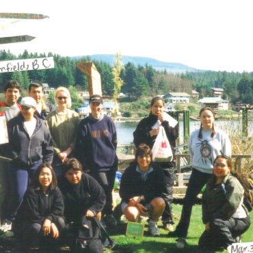 A group photo of 11 students from UBC Faculty of Education’s Indigenous Teacher Education Program. Photo dates back to March/April 2000. They are gathered outdoors posing for a photo.