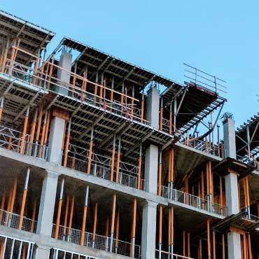 A multi-story building under construction with an exposed concrete framework.