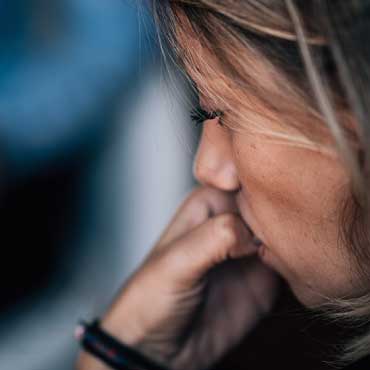 Close up of a person's face in ponder