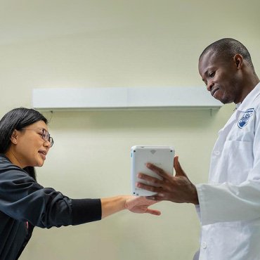 Nurse and patient interacting with a tablet