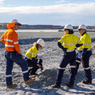 Dr. Greg Dipple, Anne-Martine Doucet and Frances Jones confer with James Rogerson, project manager with BHP Nickel West’s asset integration group at a mine at Mount Keith in Western Australia.