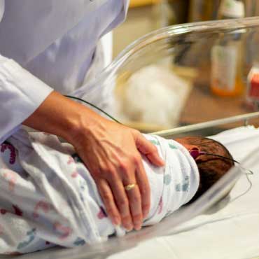 newborn sleeping in bed