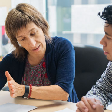 Two people discussing with documents infront of them