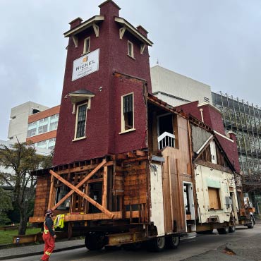 A truck transporting a firehall down the road