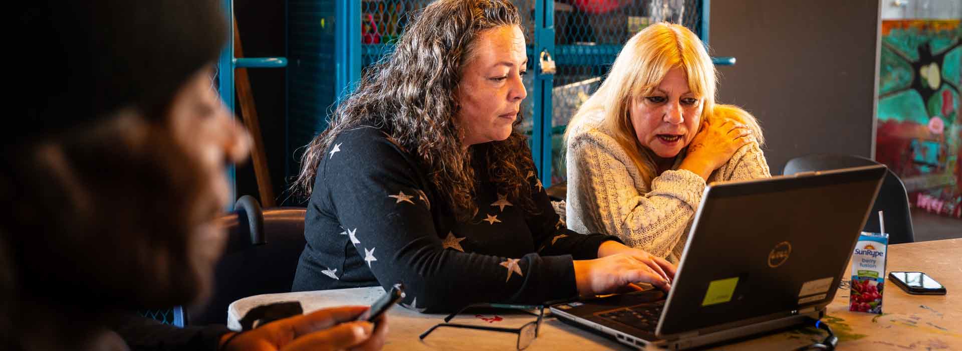 Dionne Pelan works with a community member at a Pop-Up Tech Cafe at the Oppenheimer Field House in Vancouver’s Downtown Eastside.