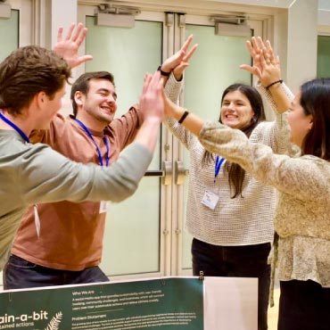 New Venture Design students Joel Cheney, Iain Copland, Anna Riley and Rynn Zhang celebrate their successful pitch of their Sustain-a-bit social media app.