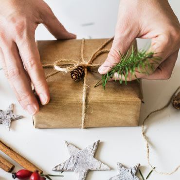 Hands wrapping a gift.