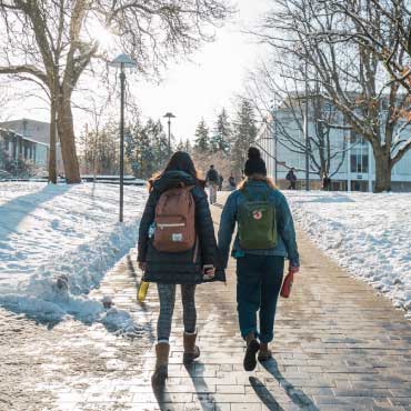 Students walking on UBC Vancouver campus covered with snow.