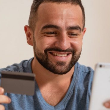 Person holding credit card and phone in hands