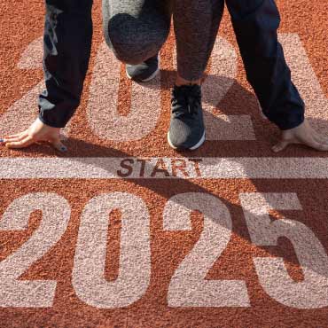 A person stands on a track marked with the years 2024 and 2025