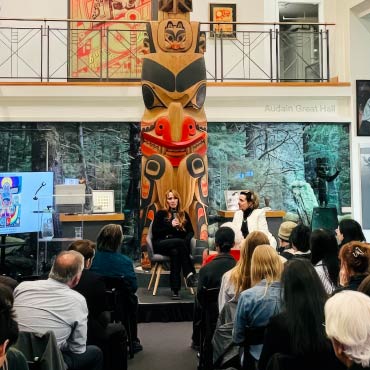 Dr. Melissa Perreault and Dr. Judy Illes discuss Two Eyed Seeing in neuroscience with an audience at the Bill Reid Gallery of Northwest Coast Art in Vancouver during Brain Awareness Week in 2023.