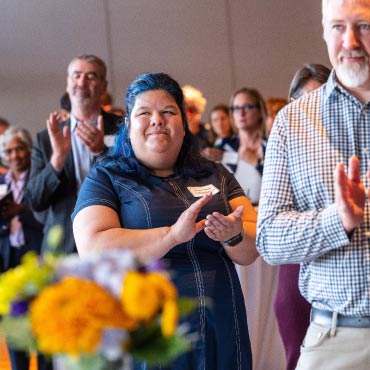 UBC staff members applauding at an event