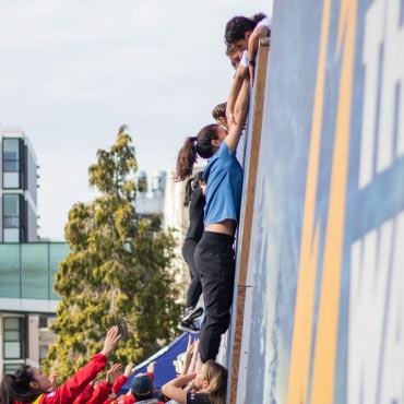 People climbing the wall at Storm The Wall at UBC.