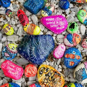 Display of rocks with art painting.